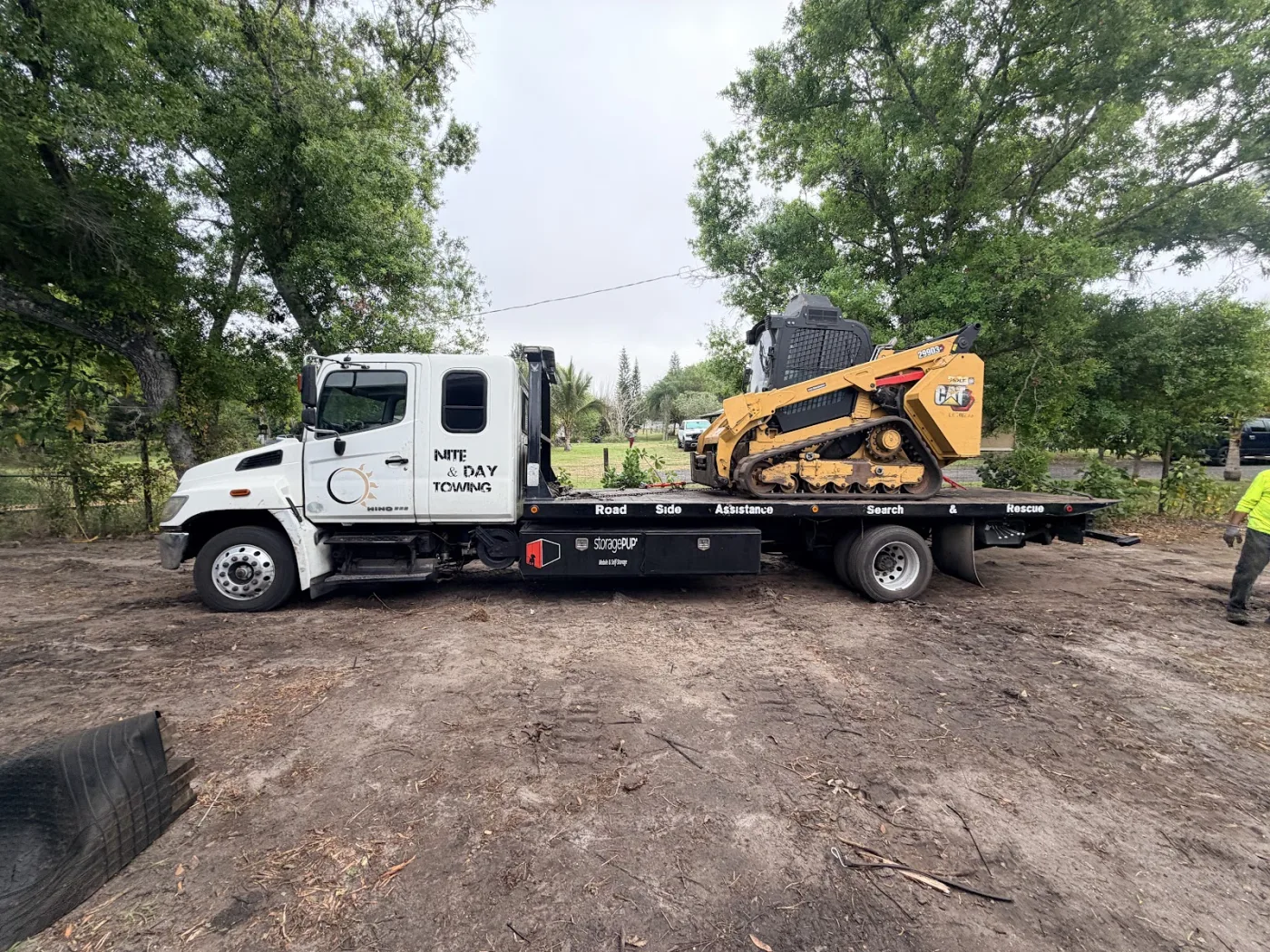 Skid steer loaded on the flatbed, headed to the next job